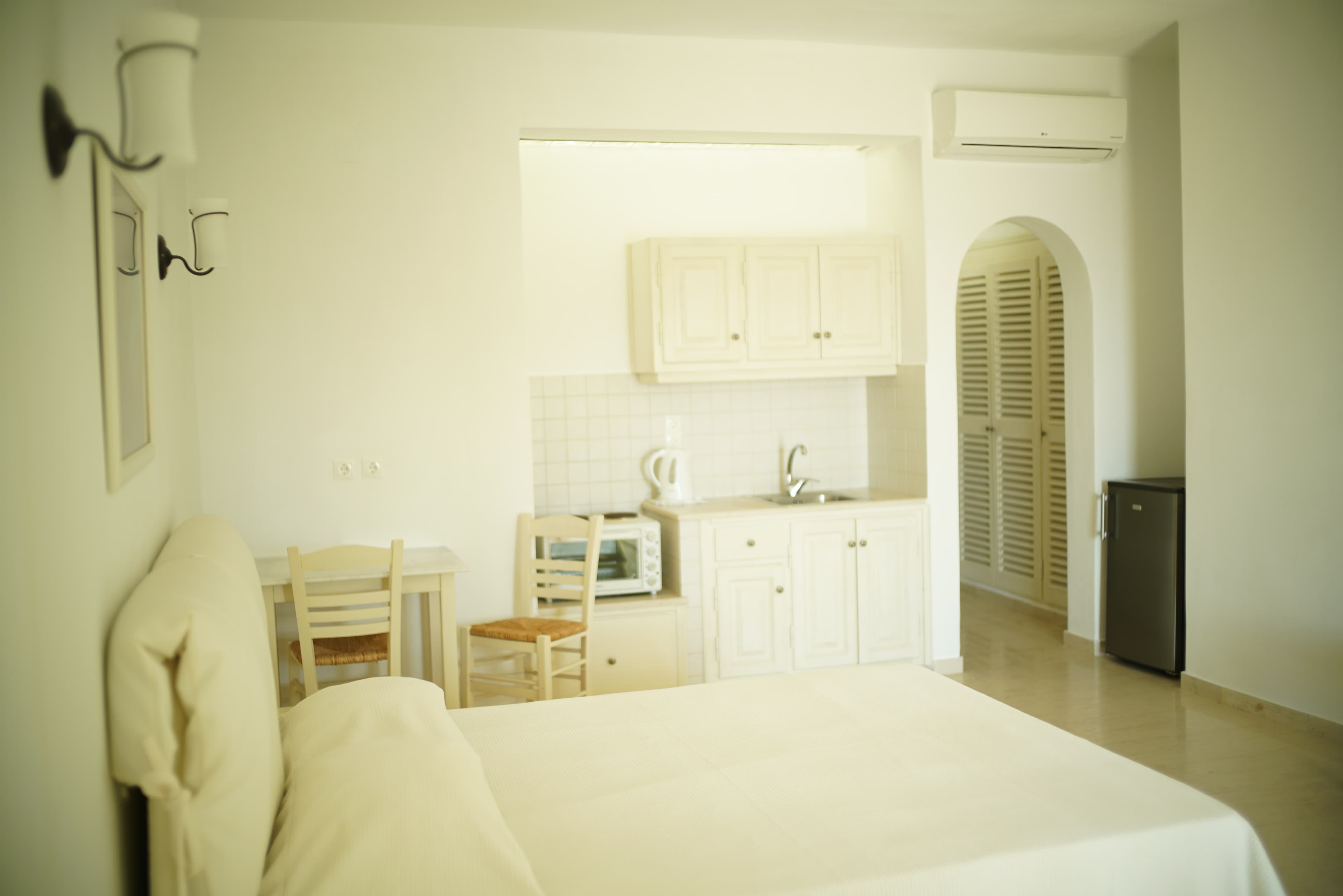 Studio bed facing the kitchenette and arched doorway