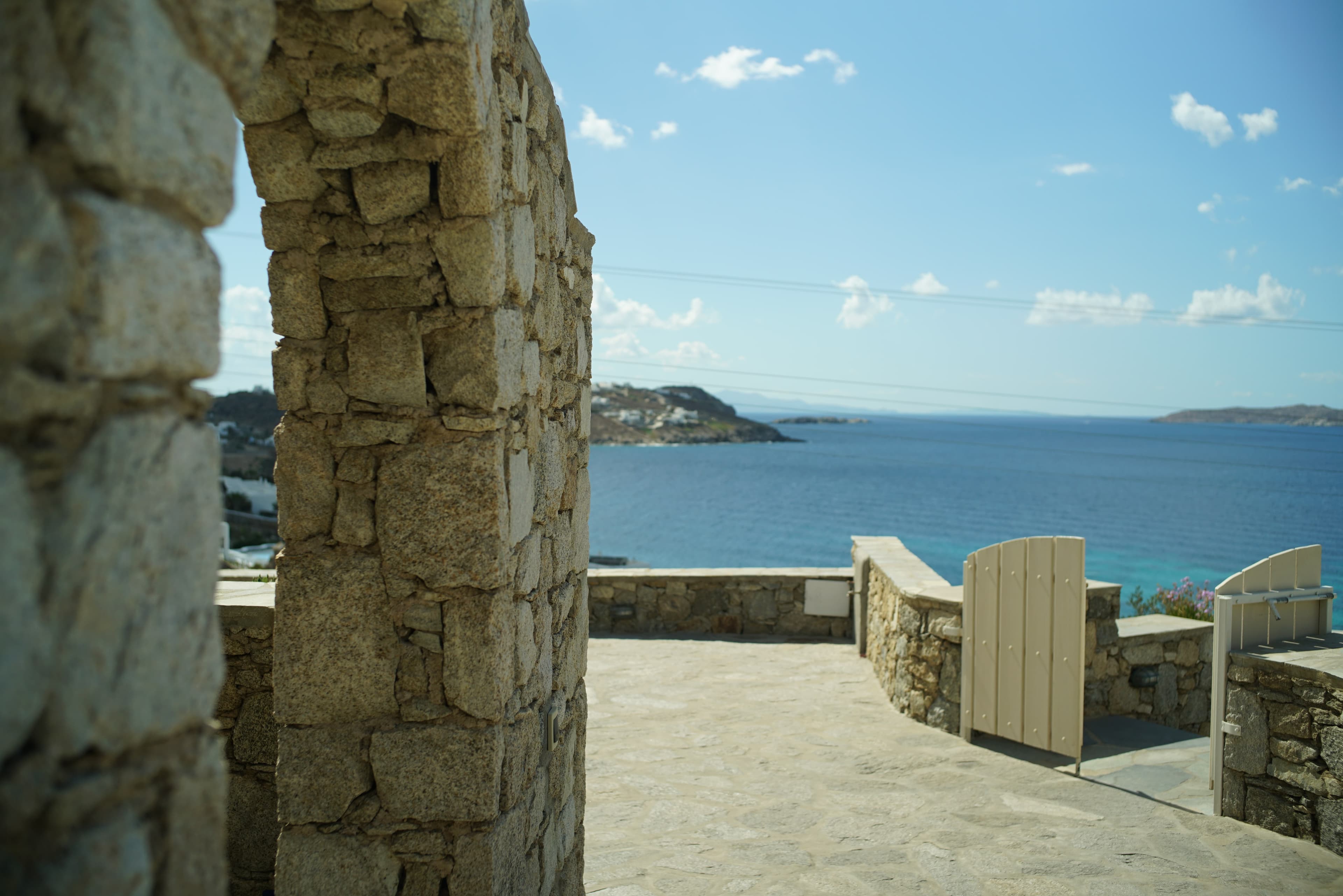 Sea visible between stone pillars and walls